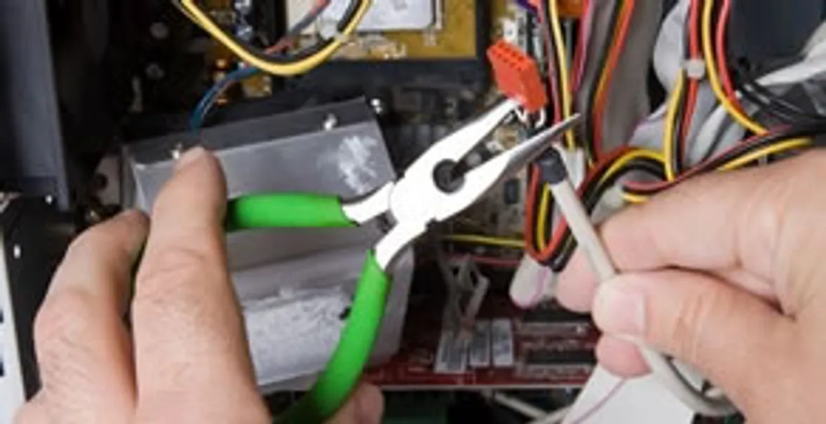 Licensed electrical contractor performing electrical repair with tools in Aurora, IL