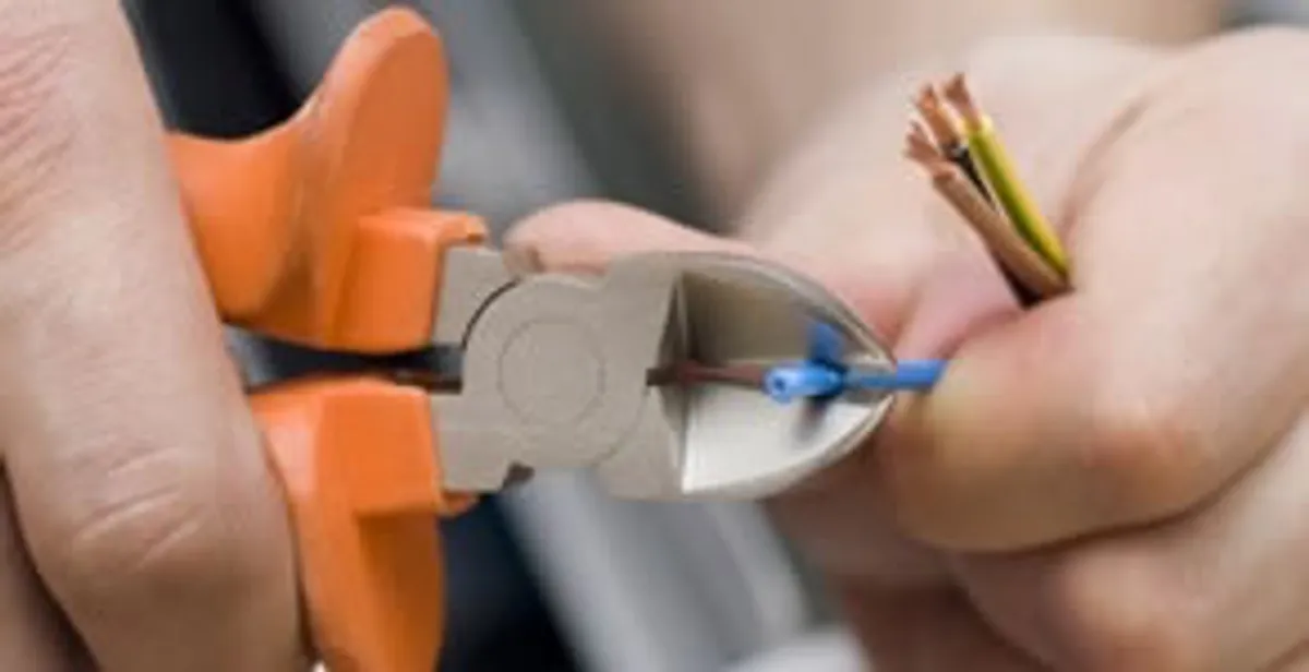 professional electrical services showing precise wire cutting by licensed electricians in Naperville, IL
